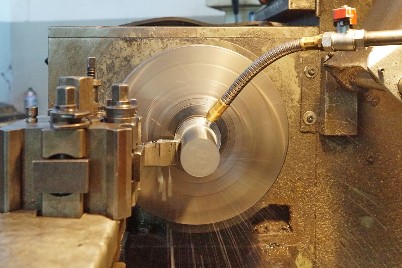 Crafting Captivating Headlines: Your awesome post title goes here Precision metal lathe in action with metal being machined, indoors workshop.