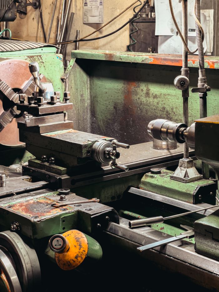 Mastering the First Impression: Your intriguing post title goes here Close-up of a metal lathe in an industrial workshop setting.